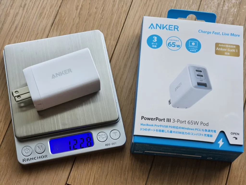 Anker 735 Charger (GaNPrime 65W)の外箱と図りで重さをはかっている本体